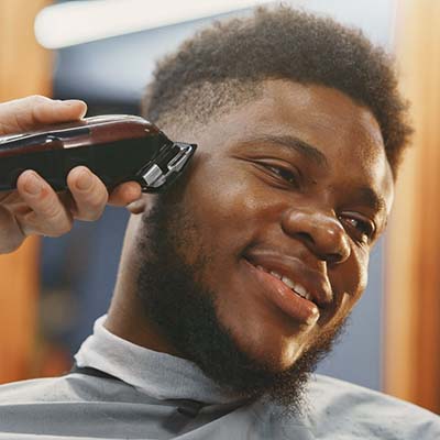 young-african-american-man-visiting-barbershop_1157-47699